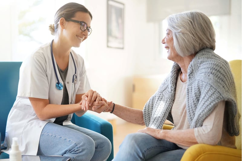 Doctor and patient having a conversation at home
