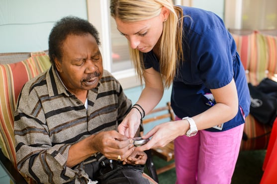 Nurse checking a patient's blood sugar