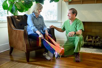 Patient exercising at home with help from therapist