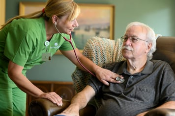 nurse caring for patient at home