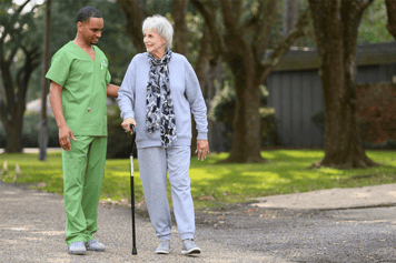 Home health care clinician assisting a patient