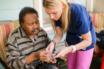 Home health clinician assisting diabetes patient