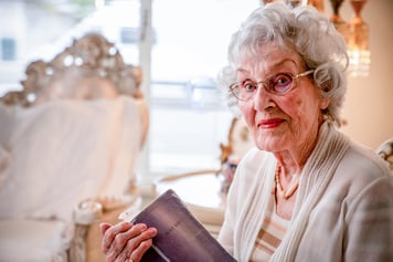 elderly woman holding Bible