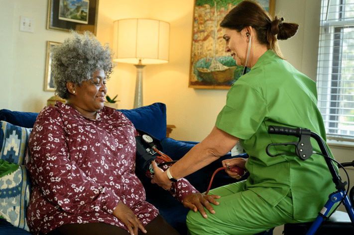 nurse taking patient's blood pressure