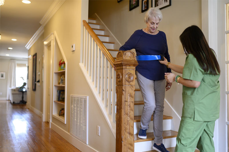 Home health clinician helping to prevent falls in the home