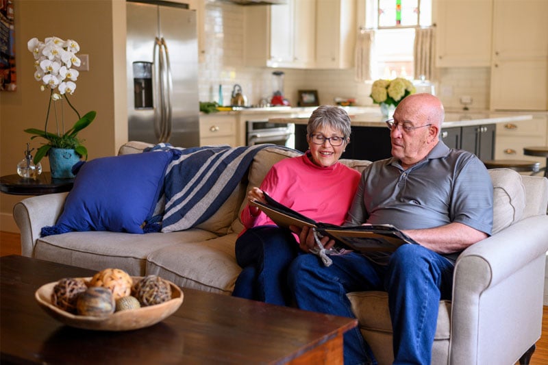 Couple looking through memories of their loved one who passed.