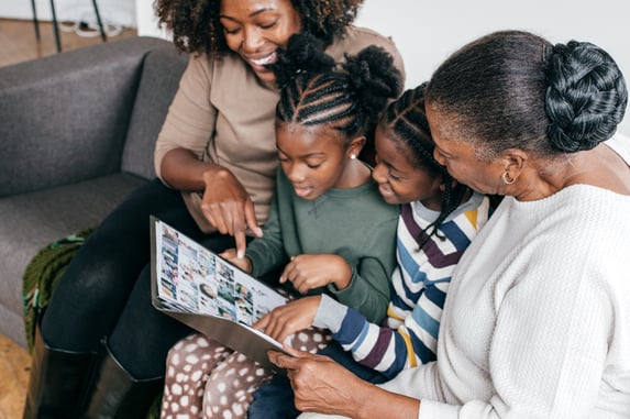 women reading a book to children