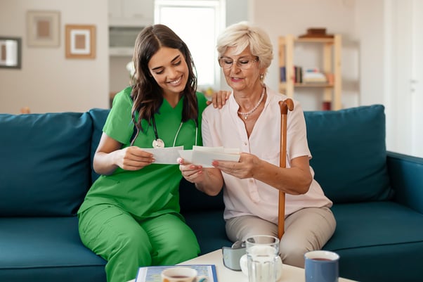 Nurse with patient reviewing papers