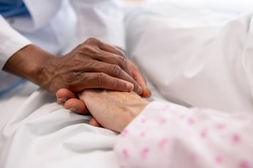 comforting hands holding patient hand