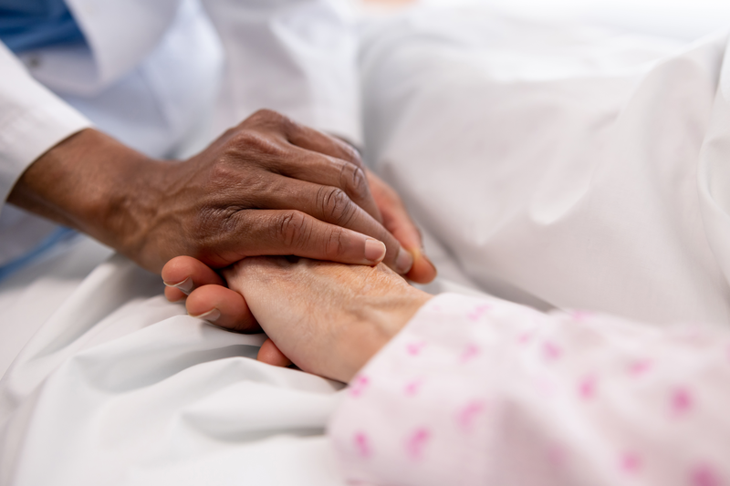 comforting hands holding patient hand