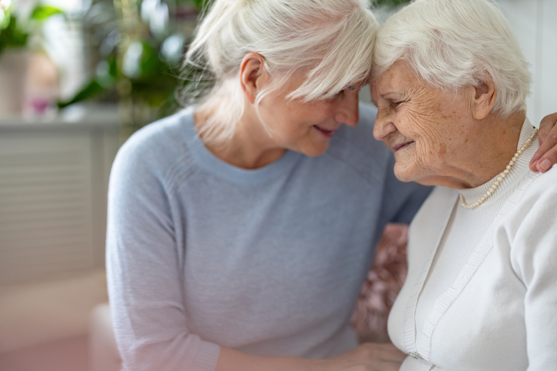 elderly women embracing