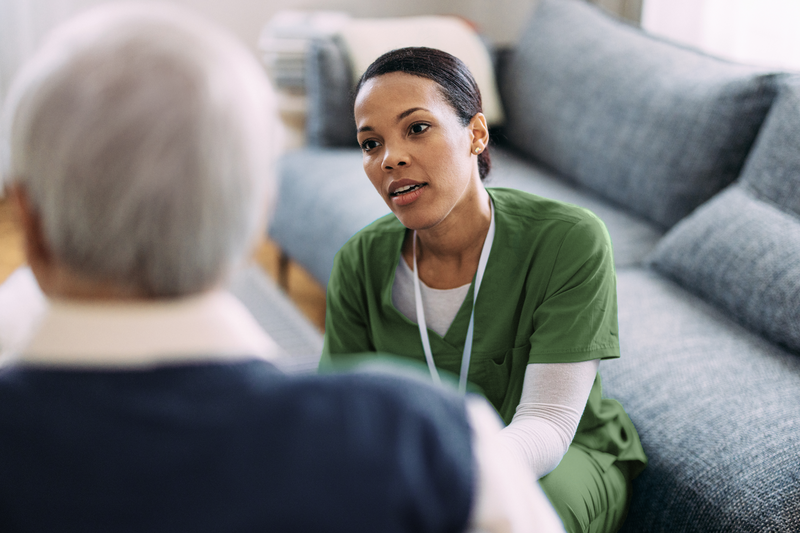 nurse in conversation with a patient