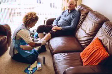 Nurse dressing wound for patient at home