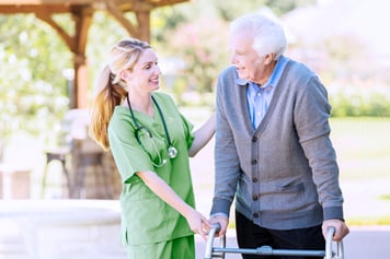 nurse and elderly man with a walker